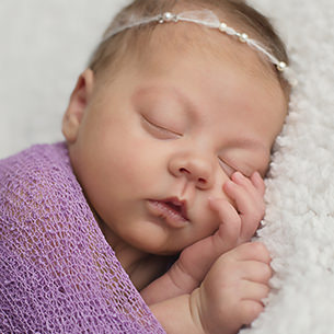 Newborn baby girl wearing dainty beaded headband tieback calgary baby session