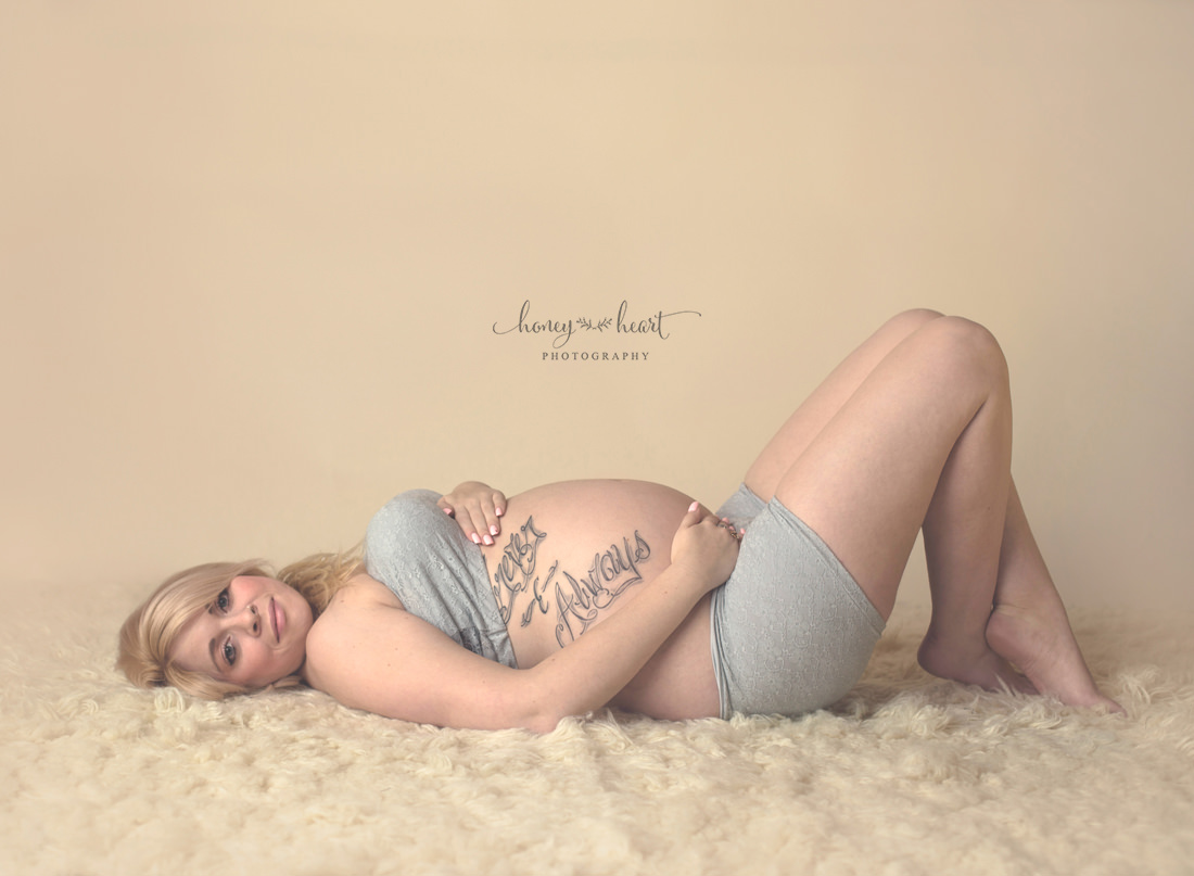 Maternity laying down pose studio photography in Calgary