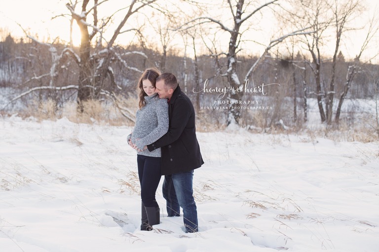 Couple maternity picture winter snow sunset dad hugging mom Calgary Maternity & Newborn Photographers