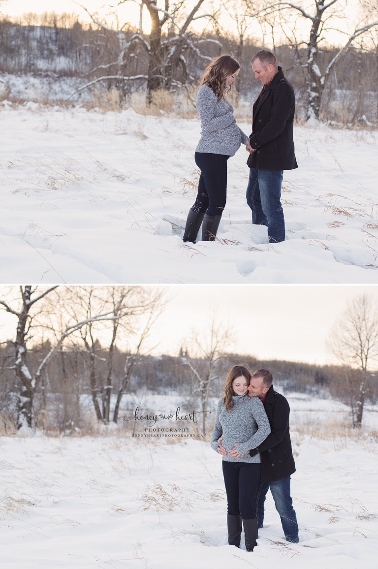 Outside winter maternity session couple facing eachother holding baby belly winter maternity session calgary