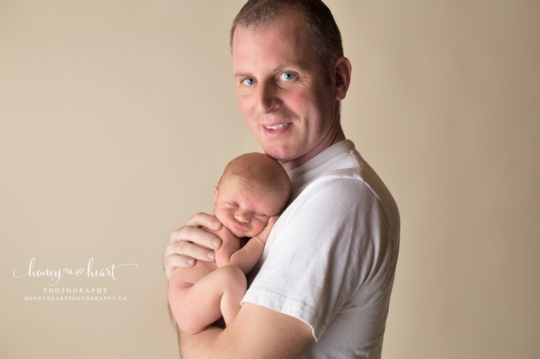 Dad and newborn baby pose studio newborn photos calgary